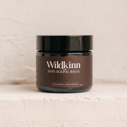 Jar of Wildkinn anti-aging balm on a beige background